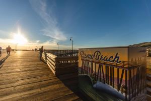 a boardwalk at the beach with people walking on it at Candlewood Suites Santa Maria, an IHG Hotel in Santa Maria