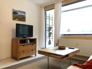 a living room with a tv and a coffee table at Ferienwohnung Held in Obertraun