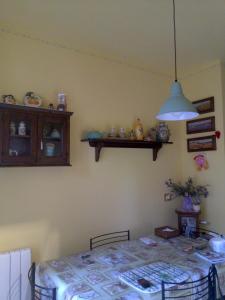 a dining room with a table and a light at Anne's House in San Giuliano Terme