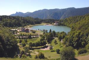 an aerial view of a lake in the mountains at Grand Hotel Astoria in Lavarone
