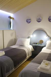 a bedroom with two beds and a table with a mirror at Marketplace Apartment 2 in Ponta Delgada