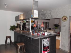 - un bar dans une cuisine avec un comptoir et des tabourets dans l'établissement Cabareté Hotel, à Capbreton