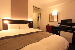 Urban Hotel Kyoto tesisinde bir odada yatak veya yataklar