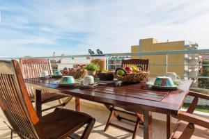 a wooden table with baskets of food on a balcony at Nathaniel Athens Airport in Spata