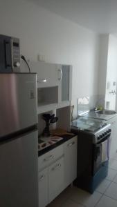 a kitchen with a refrigerator and a stove at Atacama Valley 5 in Copiapó