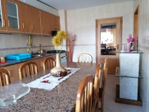 a kitchen with a table with a vase on it at Apartamento Rua da Amizade in Felgueiras