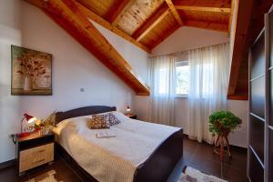 a bedroom with a bed in a room with a window at Guesthouse Ksenija in Komiža