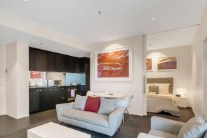 a living room with a couch and a bed at Luxury 2 bdrm in Watson at Walkerville with Balcony, FREE carpark, near Adelaide CBD in Broadview