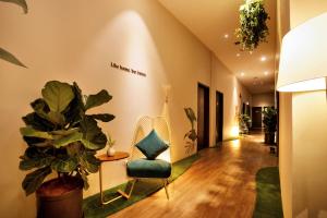 a hallway with a chair and a plant at Sojourn Spa Hotel Ipoh in Ipoh +71 photos