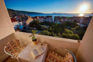 a table and chairs with a view of a city at Guesthouse Ksenija in Komiža