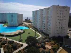 an aerial view of buildings and a swimming pool at Papudo Laguna Exclusivo in Papudo