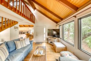 a living room with a couch and a table at 809 Treeloft Cottage in Seabrook Island