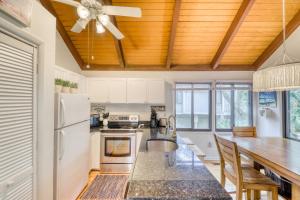 a kitchen with a table and a ceiling fan at 809 Treeloft Cottage in Seabrook Island