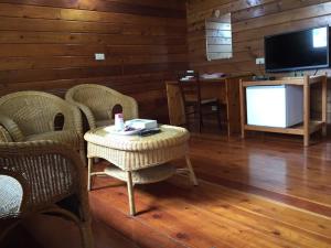 a living room with a table and chairs and a television at Tong Nian B&B in Fanlu