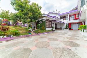a house with a courtyard in front of it at RedDoorz Syariah near Balai Kota Batu in Malang