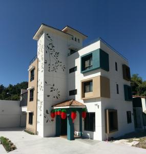 a white building with red decorations on it at 2H-share home in Yuchi