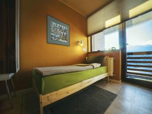 a bedroom with a bed in a room with a window at Tsar Bani Spa Resort in Gudauri