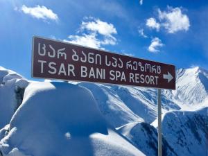 a sign on a pole on a mountain at Tsar Bani Spa Resort in Gudauri