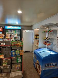 a store with a refrigerator and a box of food at Clarysville Motel in Frostburg