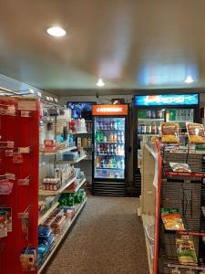 a store aisle with a refrigerator and shelves of food at Clarysville Motel in Frostburg
