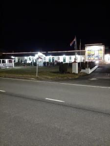 a building with a flag on the side of a road at Clarysville Motel in Frostburg