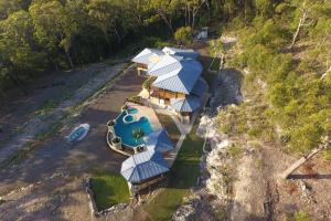 an aerial view of a house with a water park at The Pool House - Crescent Head - stunning ocean views, pet friendly in Crescent Head