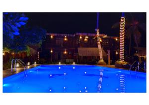 a large blue swimming pool in front of a building at Nilaveli Beach Resort - Level 1 Certified in Nilaveli