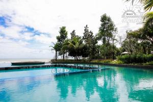 a swimming pool in front of the ocean at dipantai TIMURBAY SeaView GrdFloor Private Residence in Kuantan