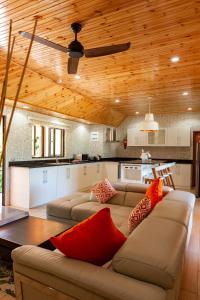 a living room with a couch and a ceiling fan at CocoLux Luxury Apartments in La Digue