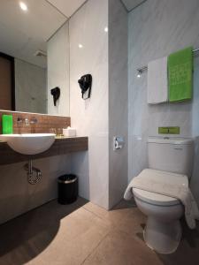 a bathroom with a toilet and a sink at MaxOne Platinum Hayam Wuruk in Jakarta