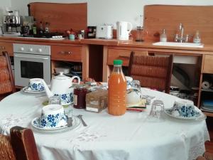 a table with a bottle of orange juice on it at Les Vignes du Château Duras Wifi et Belle vue in Duras