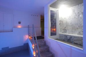 a room with a staircase with a window and a stair case at Le Camere Pinte in Sermoneta +45 photos
