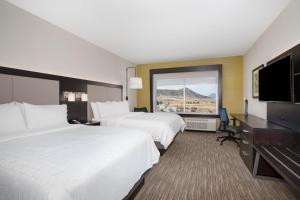 a hotel room with two beds and a flat screen tv at Holiday Inn Express & Suites - Ely by IHG in Ely