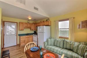 a living room with a couch and a table and a refrigerator at NC 12 56821-40 Condo in Hatteras