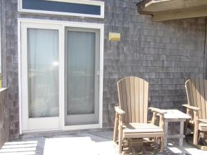 two chairs and a table on a patio at THE BAITED HOOK cottage in Frisco +19 photos