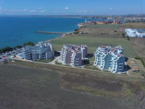 an aerial view of a group of buildings next to the water at Aparthotel Costa Calma in Aheloy