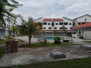 a resort with a swimming pool and some buildings at Fun Studio Pangkor in Pangkor