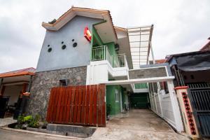 a building with a red gate in front of it at Super OYO 2808 D'residence Syariah in Tegal