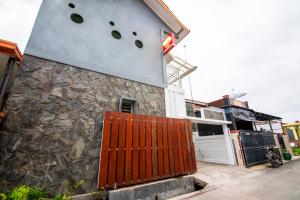 a building with a gate in front of it at Super OYO 2808 D'residence Syariah in Tegal