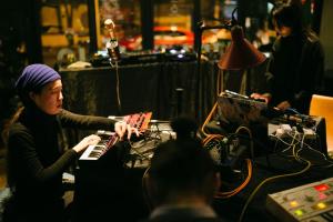 a woman playing a keyboard in a recording studio at Wadangwashe Chunxi Road Travelling With Hotel in Chengdu