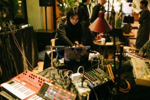 a woman sitting in a recording room with a mixer at Wadangwashe Chunxi Road Travelling With Hotel in Chengdu