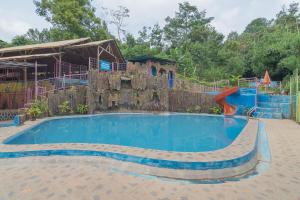 a large swimming pool with a slide in a playground at RedDoorz Resort Syariah @ Batu Apung Purwakarta in Purwakarta