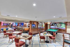 a casino with tables and chairs and a pool table at Club Mahindra White Meadows Manali in Nagar