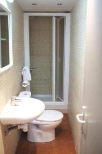 a bathroom with a toilet and a sink at Hostal Europa in Barcelona