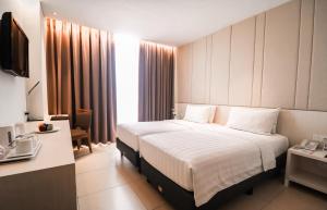 Postel nebo postele na pokoji v ubytování PRIME PARK Hotel Bandung + 34 fotografií