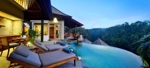 a pool at a villa with a view of the mountains at Kenran Resort Ubud By Soscomma in Ubud