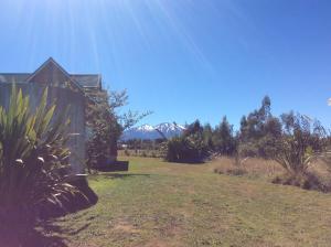 a house in a field next to a yard at The Gables B&B in Ohakune