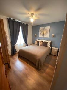1 dormitorio con 1 cama y ventilador de techo en Chambres Les Plantous de Severo, en Cénac-et-Saint-Julien