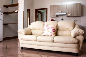 a white couch with a pillow on it in a kitchen at B&B L'Aurora CAPUA in Capua