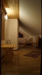 a room with a wooden bench and a table at Pensiunea Casa Maria in Buşteni +40 photos